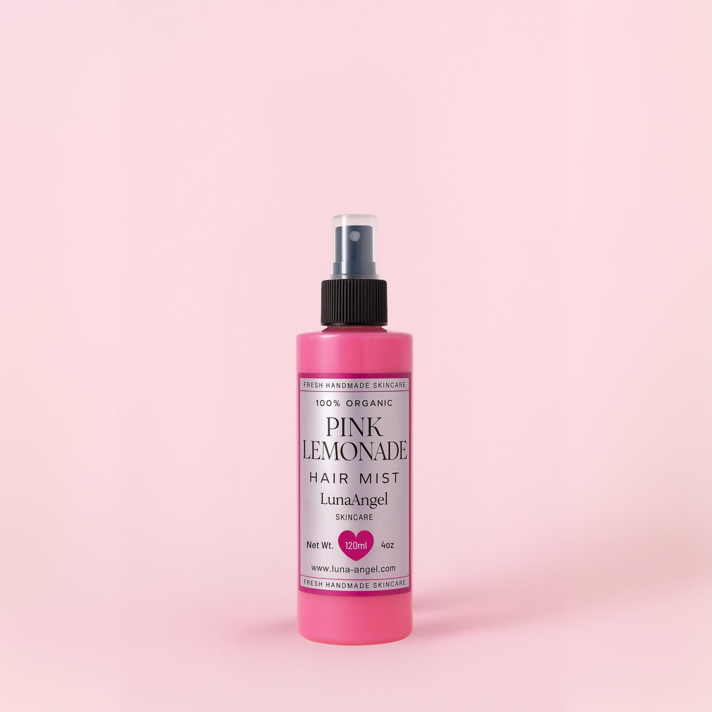 Pink Lemonade hair mist bottle on a pink background