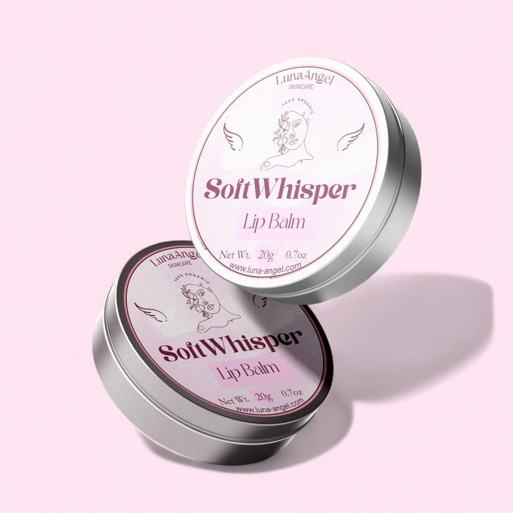 Two tins of LunaAngel Soft Whisper Lip Balm on a pink background