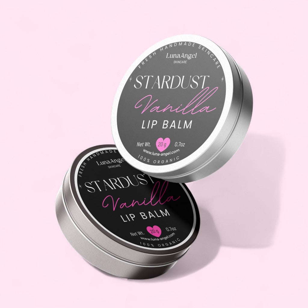 Stardust Vanilla lip balm tin with pink label on a light pink background