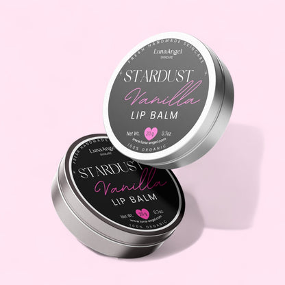 Stardust Vanilla lip balm tin with pink label on a light pink background