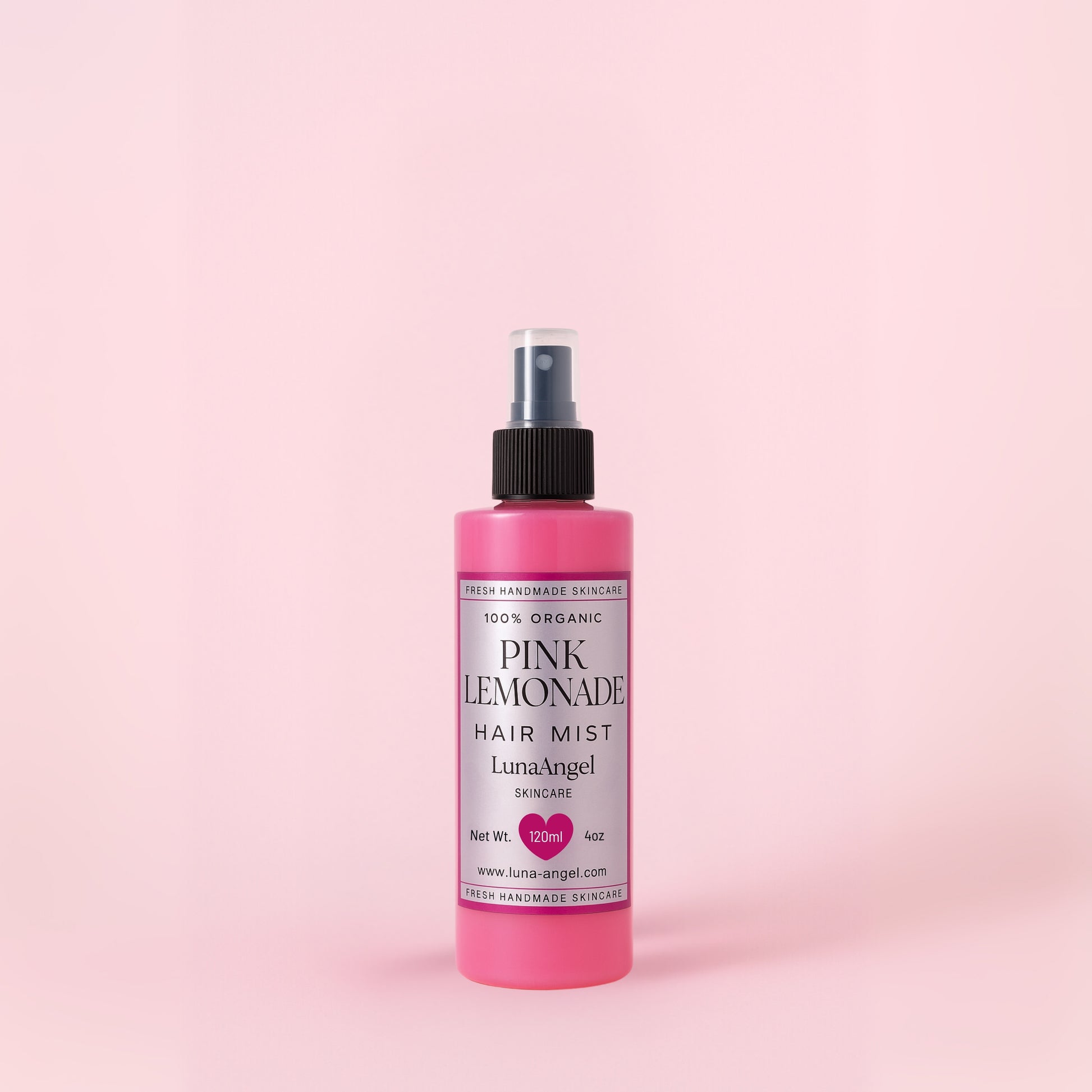 Pink Lemonade hair mist bottle on a pink background