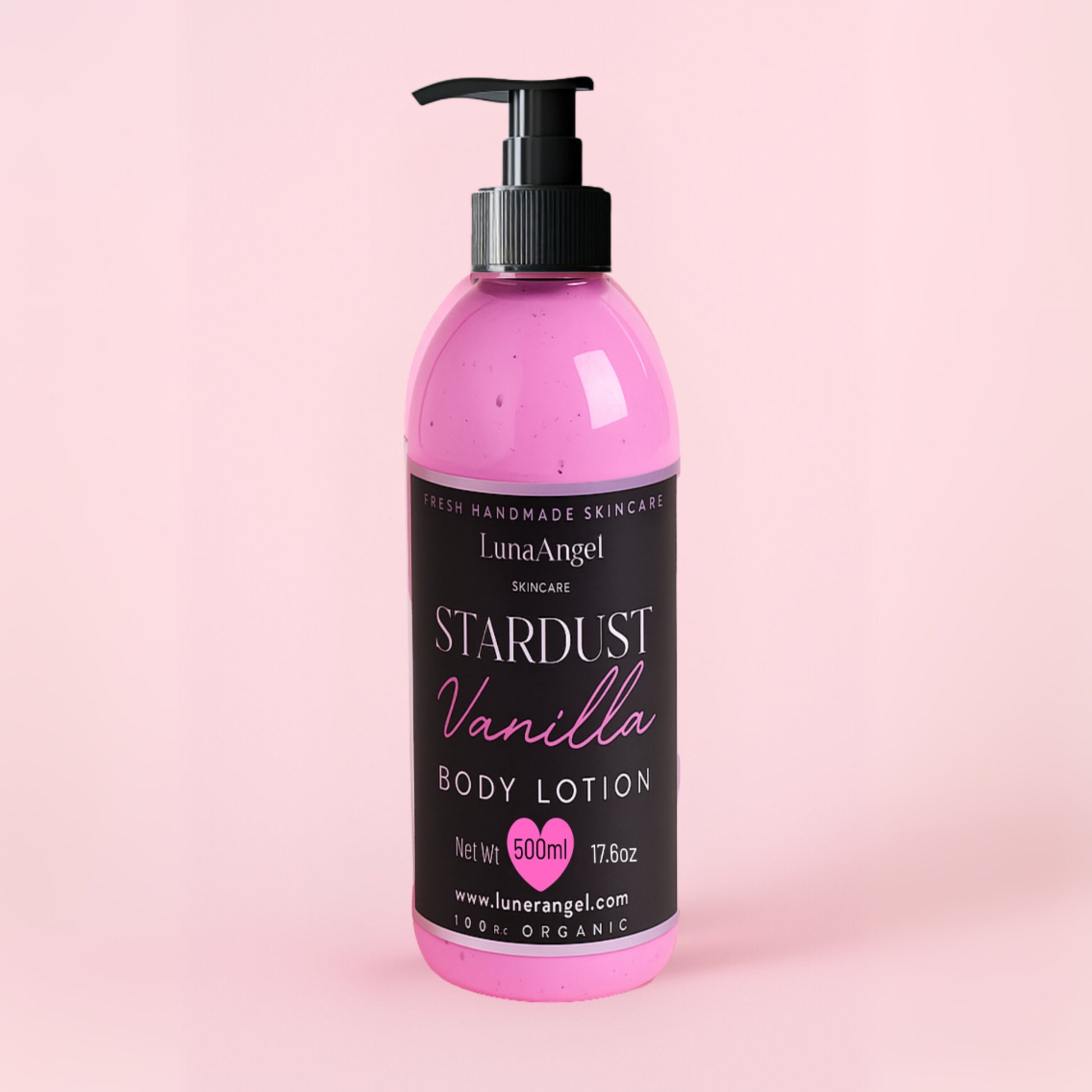 Pink body lotion bottle with black label on a pink background