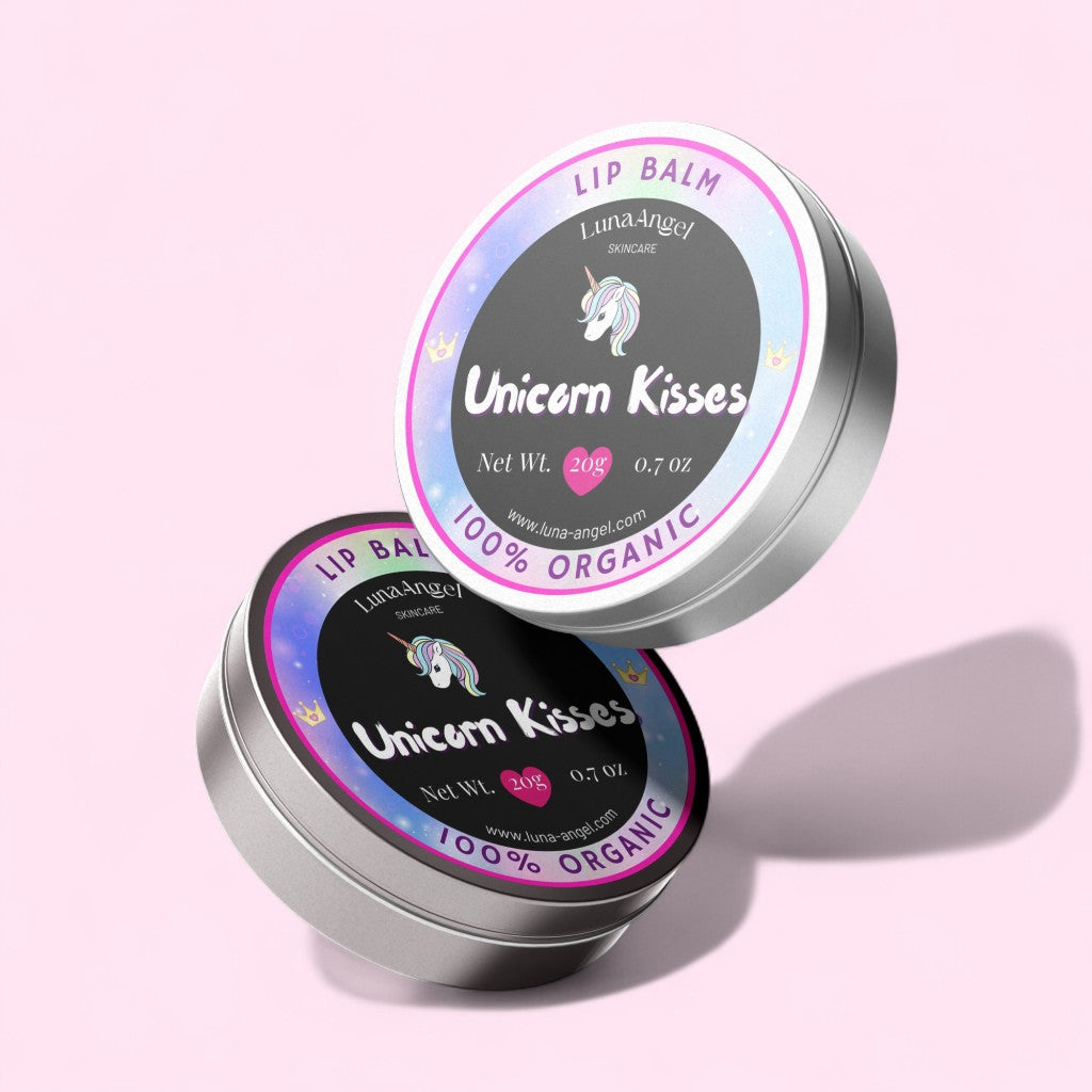Two tins of Luna Angel Unicorn Kisses lip balm on a pink background