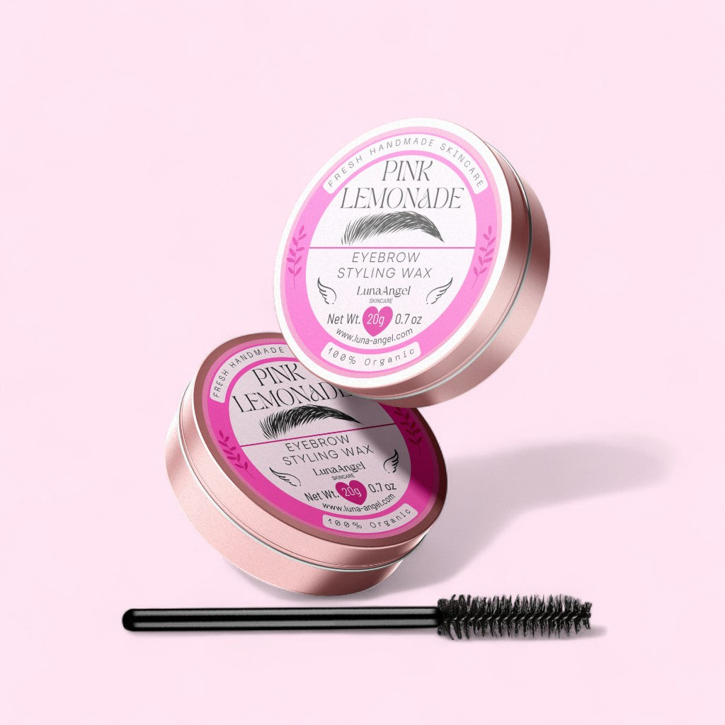 Pink Lemonade eyebrow styling wax with a comb on a pink background
