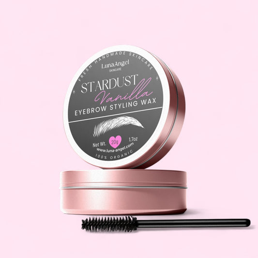 Stardust Vanilla eyebrow styling wax tin with brush on a light pink background – organic LunaAngel skincare product, 20g