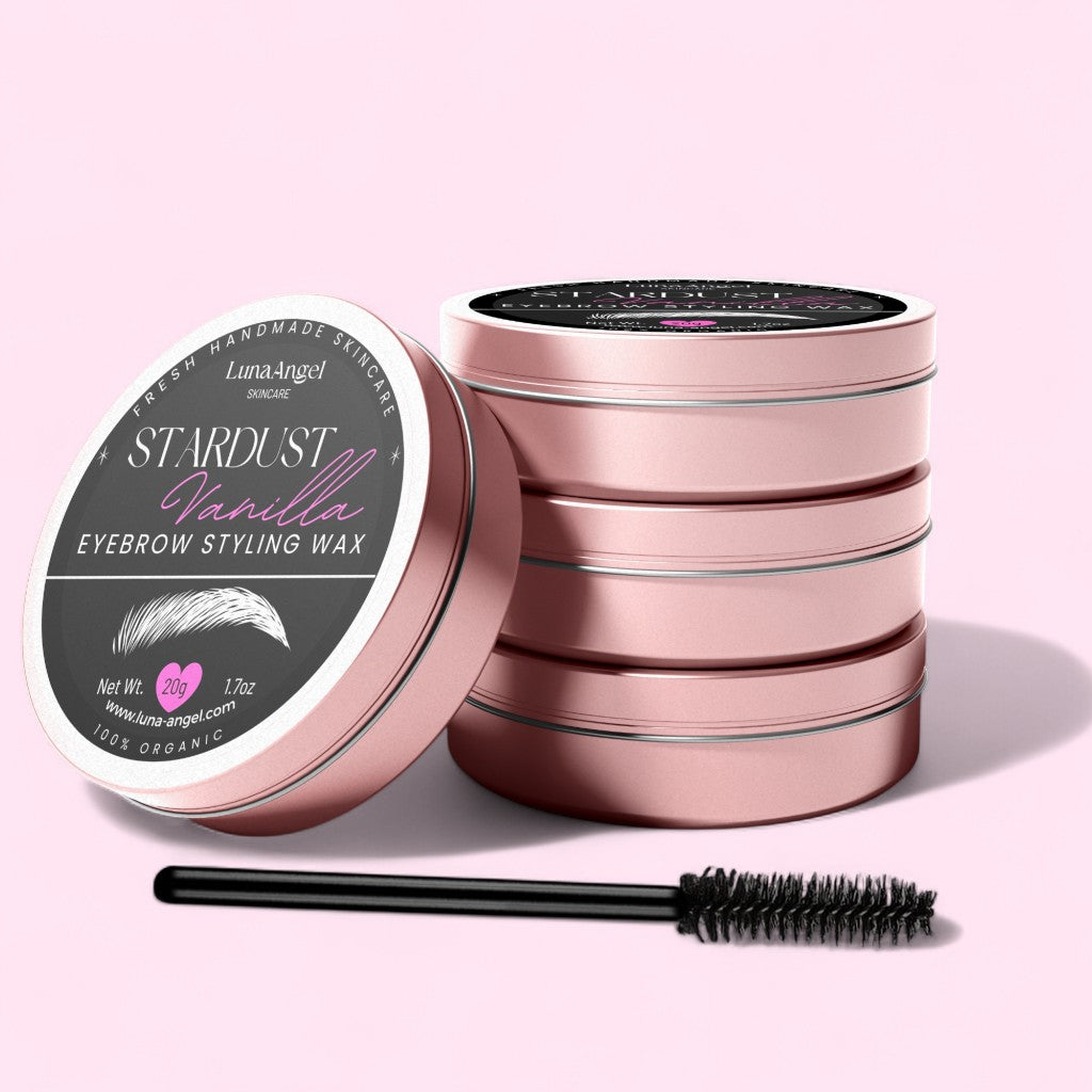 LunaAngel Stardust Vanilla eyebrow styling wax tins stacked with applicator brush on a light pink background – organic 20g product