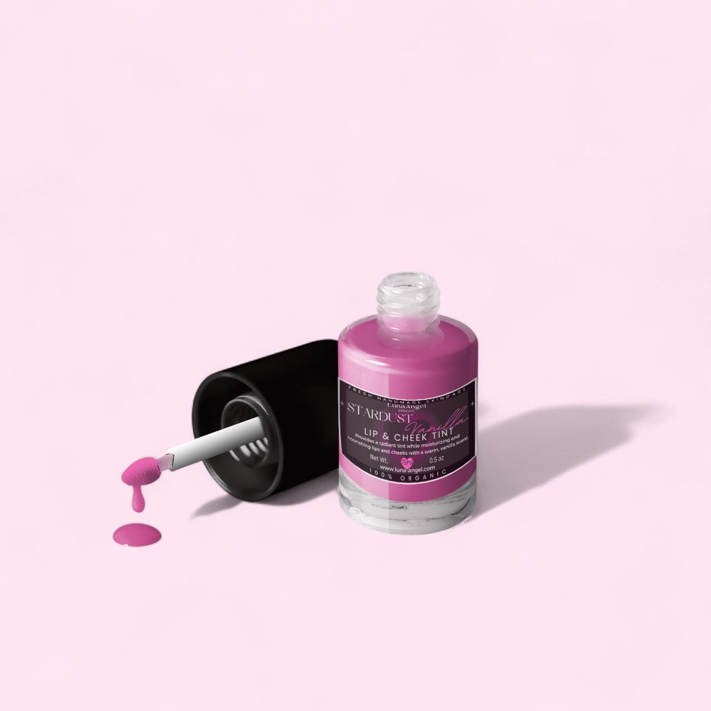 Pink lip and cheek tint bottle with applicator on a light pink background